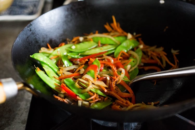 Singapore noodles— stir-fried rice noodles with curry, tofu and vegetables—a Chinese take out menu classic - easy recipe, vegetarian and full of authentic flavor! #meifun #singaporenoodles #currynoodles #chinesenoodles #stirfry #stirfrynoodles #vegetarian #noodles