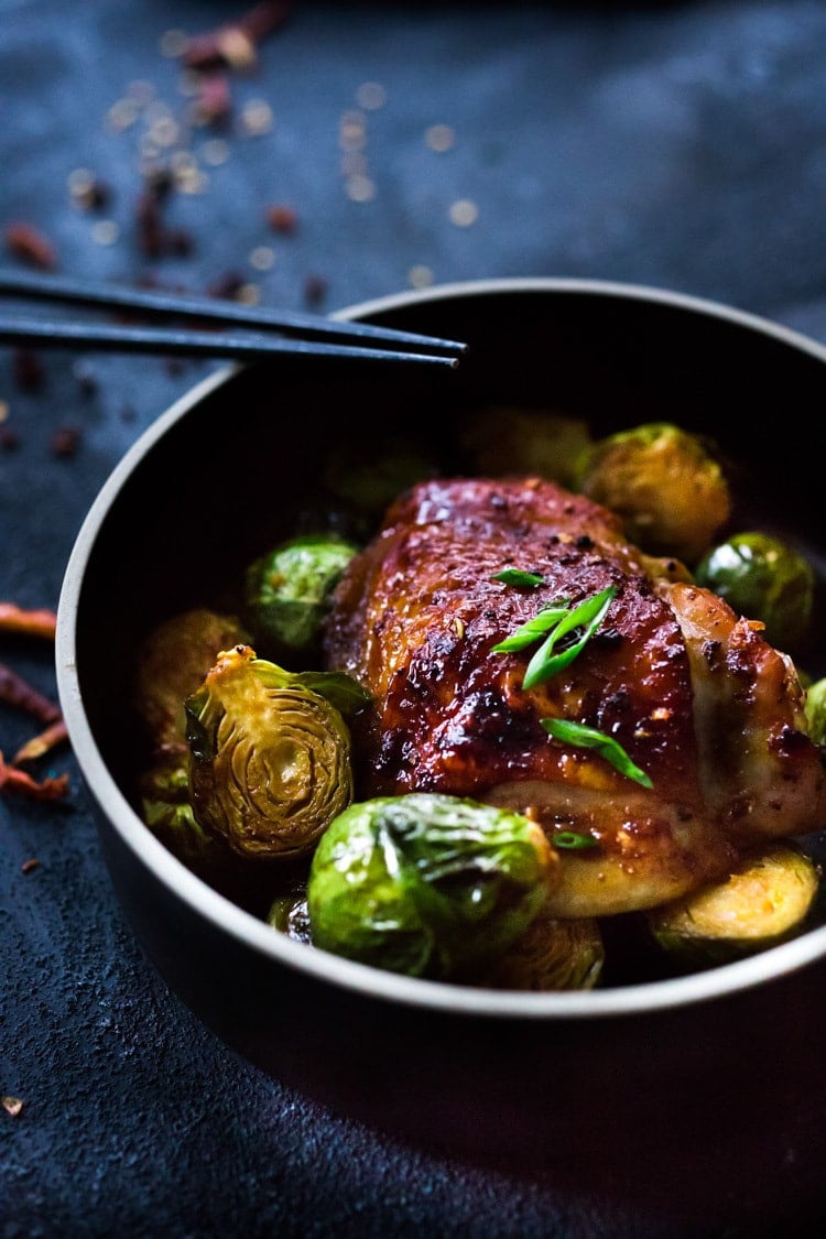 Sheet-Pan Szechuan Chicken (or Tofu) with Brussel Sprouts takes only 15-20 minutes of hands on time before baking in the oven. A full-flavored weeknight dinner your whole family will love! #sheetpandinner #szechuanchicken #szechuan #szechuansauce #sheetpanchicken #roastedbrusselsprouts