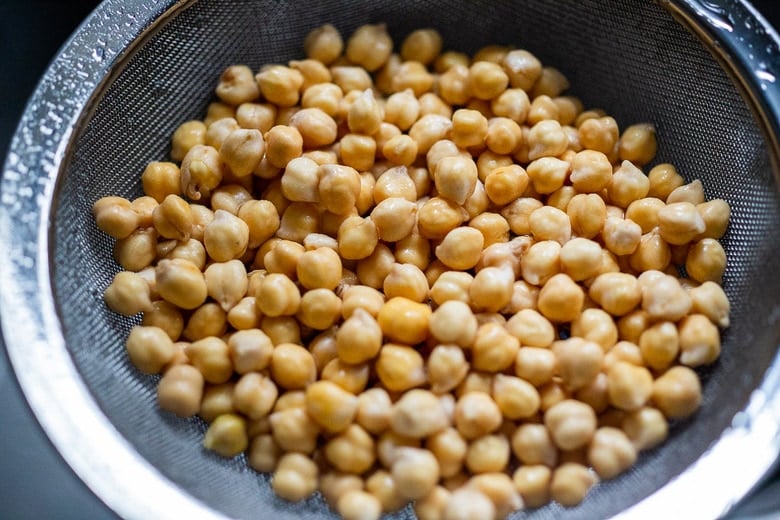 cooked chickpeas in fine mesh strainer. 