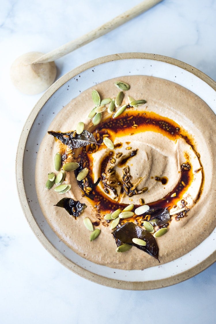 Tandoori Hummus - a delicious Indian twist on the classic, seasoned with garam masala spice. This healthy homemade hummus is vegan, easy to make... and has the BEST flavor! Serve with naan or pita! #humus #hummus #howtomakehummus #vegan #indianrecipes #garammasala #cleaneating #plantbased #eatclean #vegan #snacks #dips