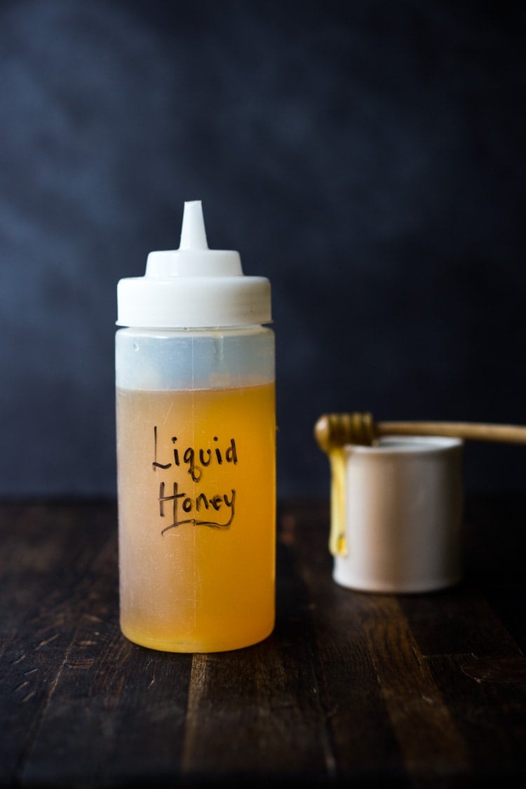 How to make Honey Simple Syrup - an easy way to revive old honey or keep honey loose and liquid so it's easy to pour and mix into vinaigrettes, marinades and drinks! #honeysimplesyrup #liquidhoney #honey #alternativesweetener #eatingclean #cleaneating #eatclean