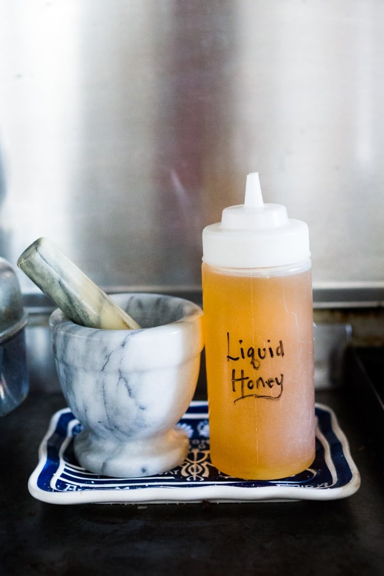 How to make Honey Simple Syrup - an easy way to revive old honey or keep honey loose and liquid so it's easy to pour and mix into vinaigrettes, marinades and drinks! #honeysimplesyrup #liquidhoney #honey #alternativesweetener #eatingclean #cleaneating #eatclean