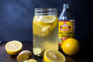 How to make a switchel- a healthy, energizing, probiotic drink made with apple cider vinegar (with the "mother" in it), lemon, ginger, honey or maple syrup- that builds healthy bacteria in the gut, lowers cholesterol, helps sheds weight, boosts immunity, aids with digestion and regularity and increases energy and vitality! #switchel #switzel #probiotics #guthealth #healthydrinks #healthygut #healthybacteria #detox #cleaneating #eatclean #applecidervinegar #drink #water #ginger