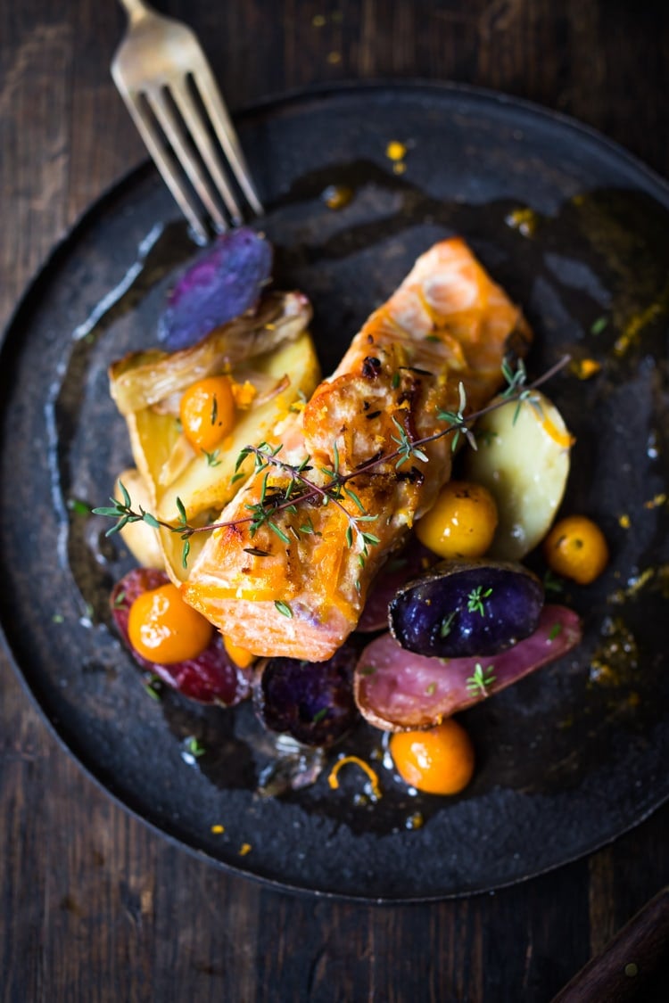 Citrus Baked Salmon with roasted fingerlings and kumquats in a flavorful citrus marinade. With only 15 minutes of hands on time, this simple easy diner recipe is perfect for busy weeknights! #salmonbake #roastedsalmon #healthysalmon #bakedsalmon #weeknightdinner #kumquats #fingerlings #citrus #citrussalmon #sheetpandinner