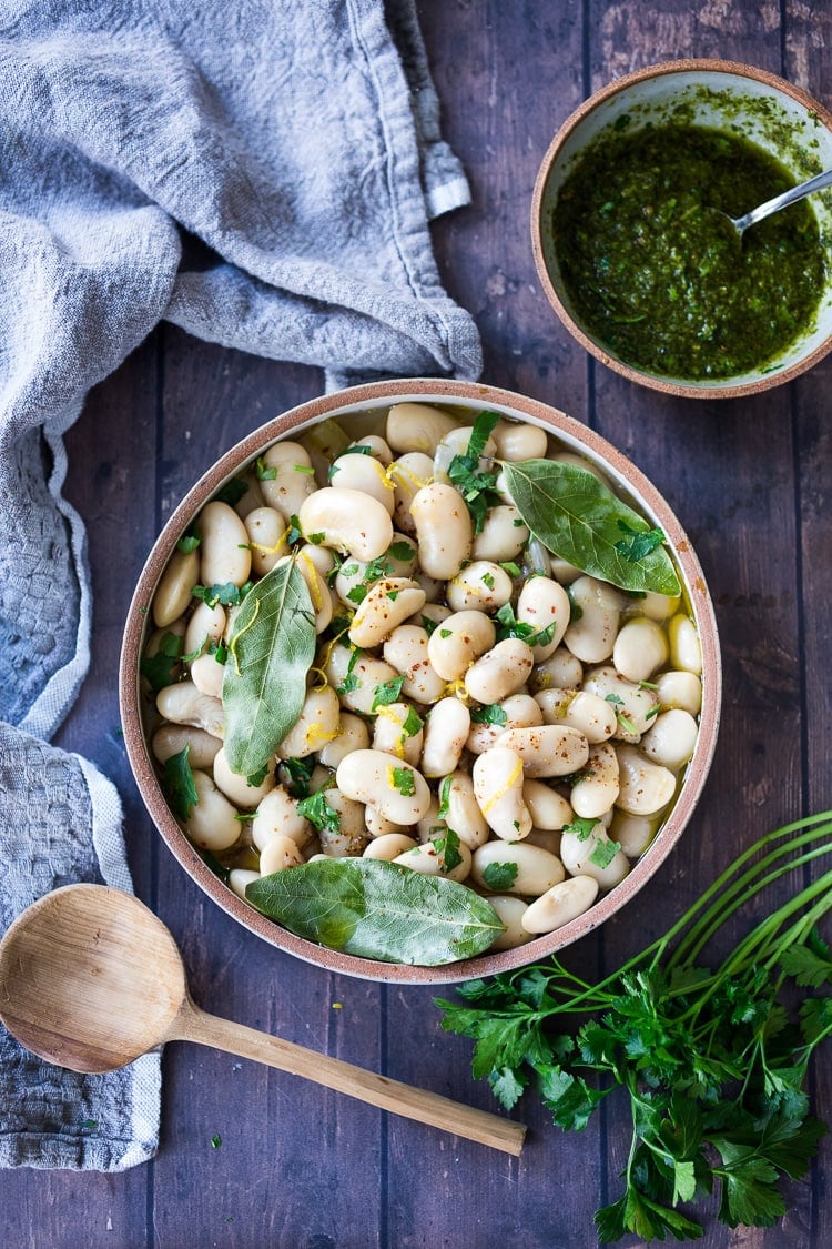 A simple recipe for Corona Beans - giant butter beans (also known as lima beans or Gigante beans) seasoned with olive oil, garlic, fresh herbs, and lemon zest. Serve as a vegan main dish or side dish or add to salads, soups and Buddha Bowls. Can be made in an Instant Pot!