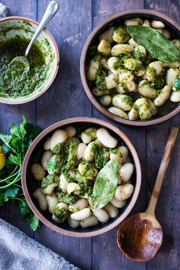 A simple recipe for Corona Beans - giant butter beans (also known as lima beans or Gigante beans) seasoned with olive oil, garlic, fresh herbs, and lemon zest. Serve as a vegan main dish or side dish or add to salads, soups and Buddha Bowls. Can be made in an Instant Pot!