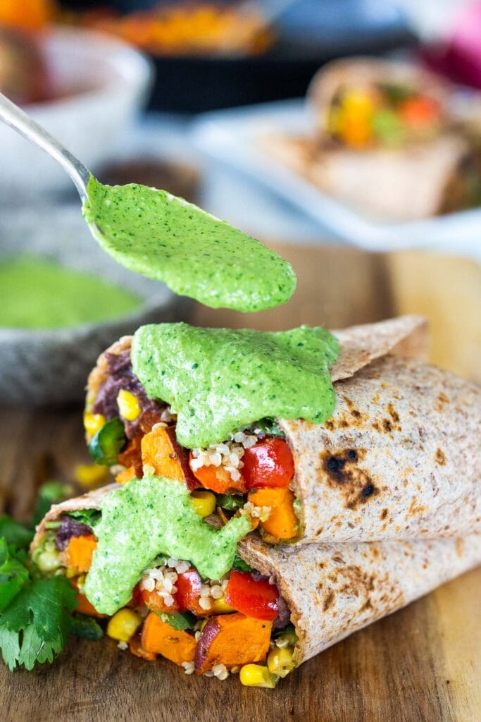 Peruvian burritos with quinoa and black beans and a spoonful of aji verde sauce. 