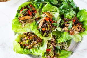 Delicious Vegan Lettuce Wraps are filled with Teriyaki Mushrooms and brown rice- an easy Asian-inspired lunch idea or appetizer that is healthy and satisfying. #veganlunch #vegan #veganlettucewrap #shiitakewrap