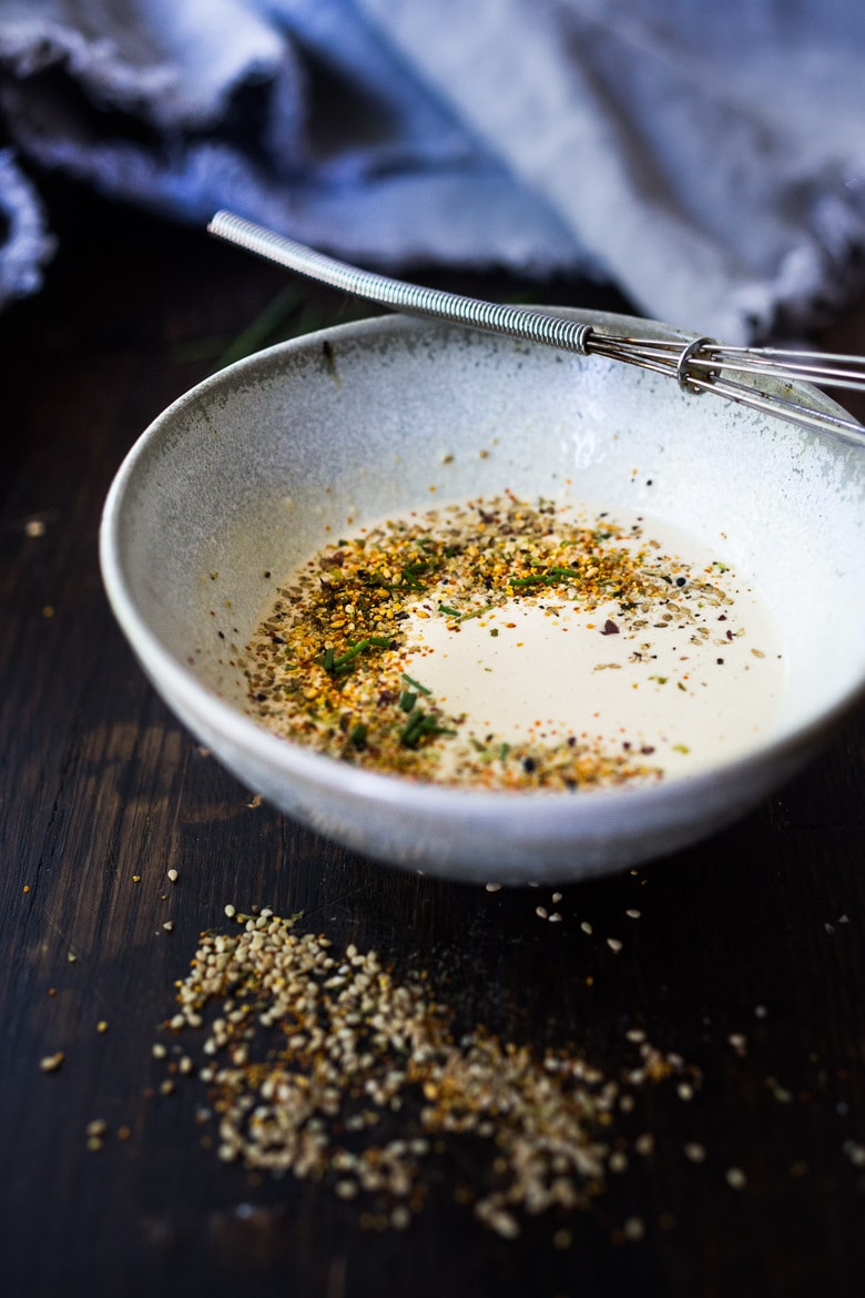 small bowl with Japanese-inspired caesar dressing topped with furikake.