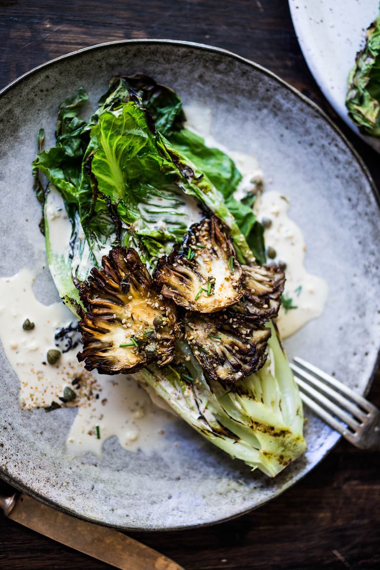 grilled romaine salad with maitake mushrooms served with caesar dressing, capers, and furikake.