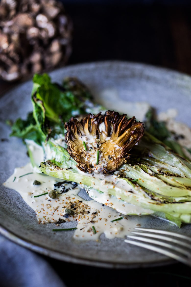 grilled romaine salad with maitake mushrooms, caesar dressing, capers, furikake, chives.