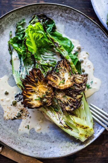 This Grilled Romaine Salad is topped with grilled Maitake Mushrooms—and tossed in a Furikake Caesar dressing that comes together in 20 minutes! Vegan-adaptable.