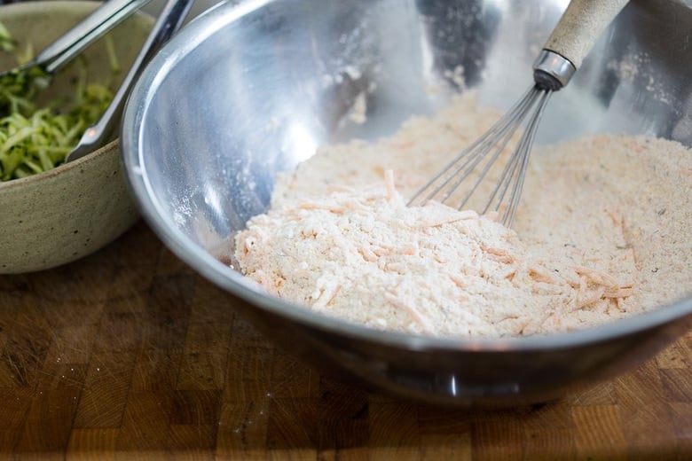 mixing bowl with flour and grated cheddar cheese and whisk.