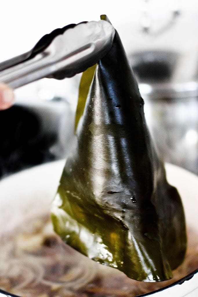tongs picking Kombu out of the broth.