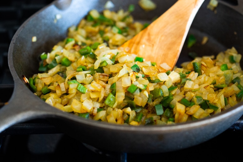 saute onion, garlic and poblano peppers in a skillet. 