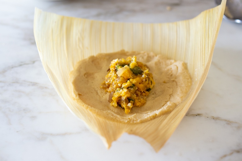 adding the filling to the tamales!