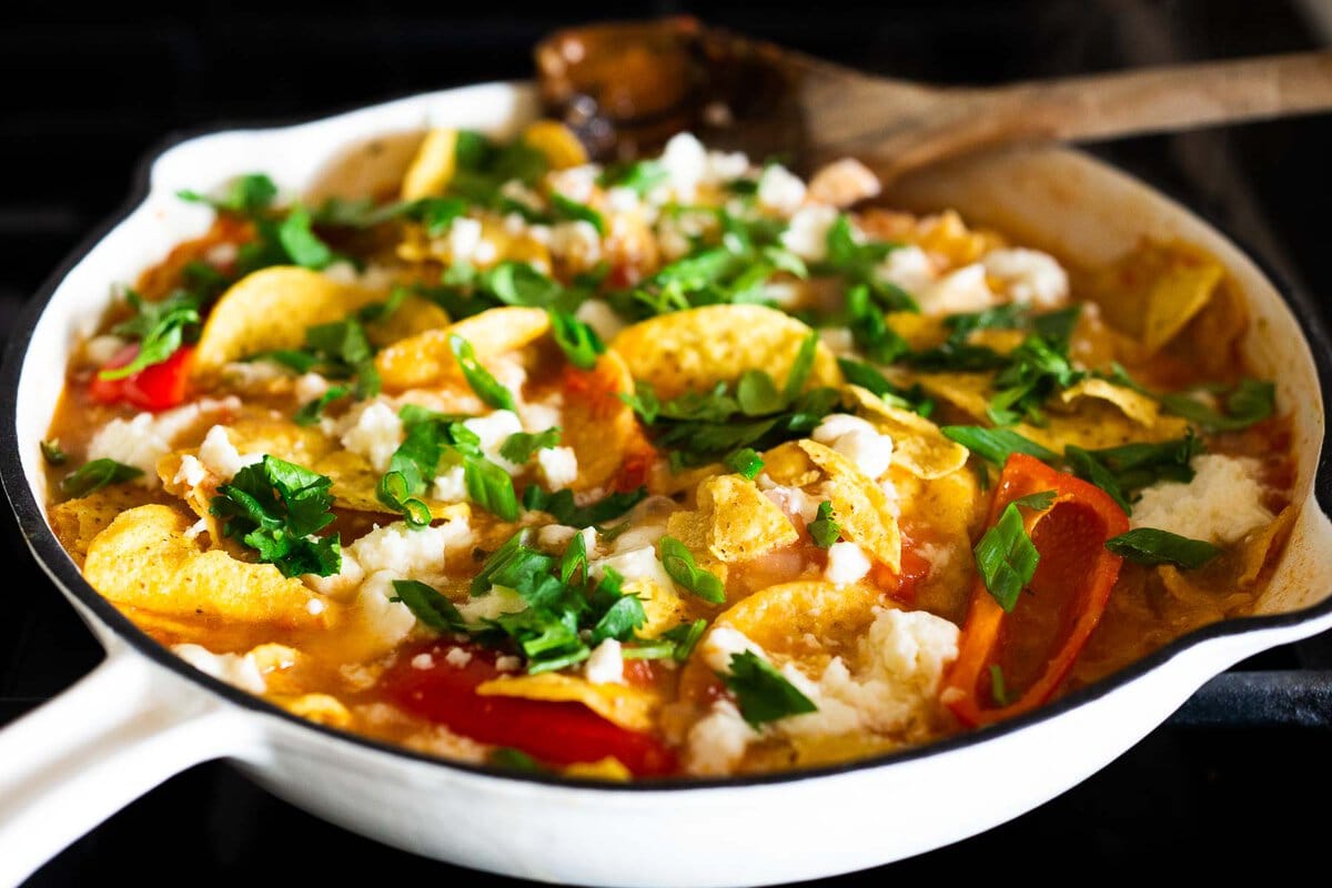 chilaquiles in a skillet right before going into the oven. 