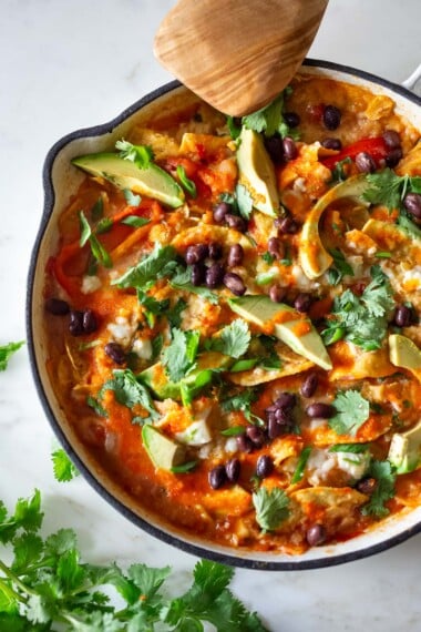 How to make the best chilaquiles! A simple Mexican meal loaded up with healthy veggies, beans, and tortilla chips that can be made in under 30 minutes, perfect for breakfast, brunch or a quick weeknight dinner. Vegetarian. Video. 