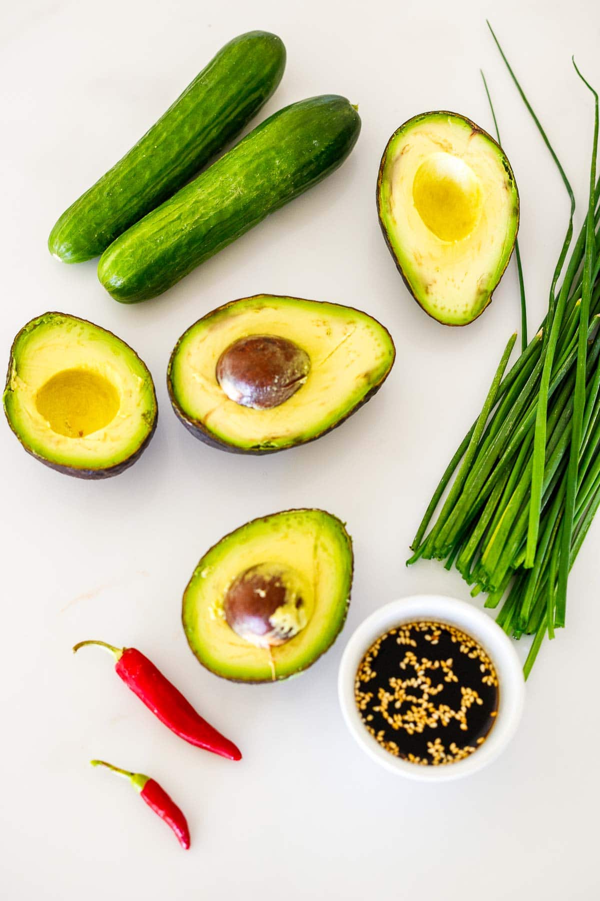 avocado salad ingredients- avocados, cucumbers, scallions, chili pepper, and a ponzu dressing. 