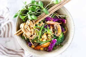 Flavorful Sesame Noodles, loaded up with healthy veggies and tossed in the most delicious, creamy, vegan Sesame Sauce! Make this in 20 minutes flat! Keep it vegan or add chicken- up to you! #sesamenoodles #vegan #noodlebowl
