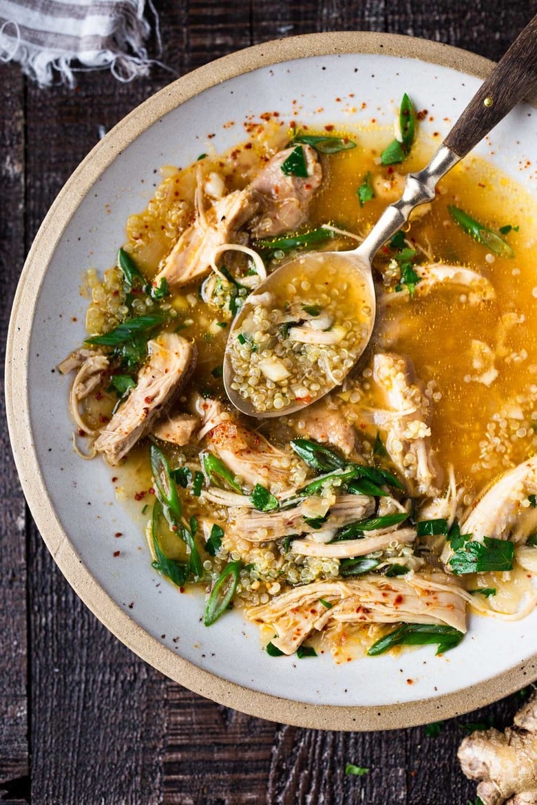 Feel Better Chicken Soup with Lemon and Ginger will warm you to your bones! Brothy and flavorful, this highly-adaptable recipe is the perfect base for your own creations- use whatever grain or starch you prefer- noodles, rice quinoa, beans- or keep it keto and low-carb! Can also be made in an Instant Pot or Slow cooker! #chickensoup #ketosoup #broth