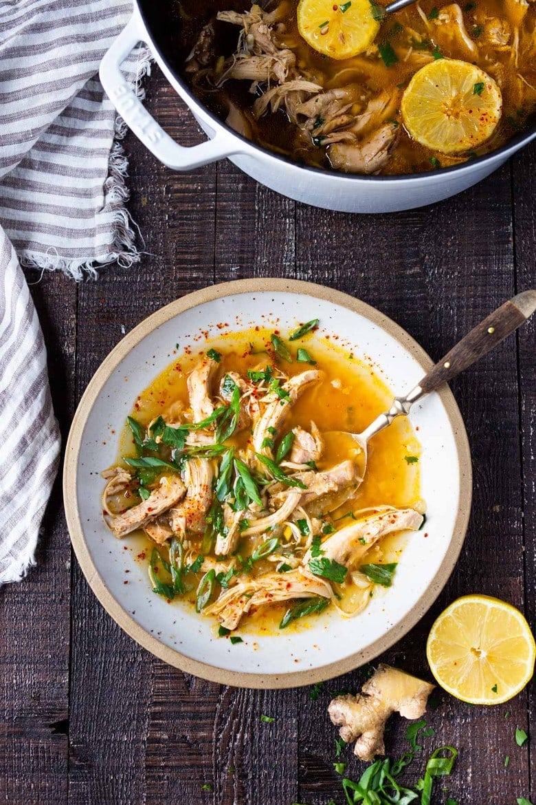 Feel Better Chicken Soup with Lemon and Ginger will warm you to your bones! Brothy and flavorful, this highly-adaptable recipe is the perfect base for your own creations- use whatever grain or starch you prefer- noodles, rice quinoa, beans- or keep it keto and low-carb! Can also be made in an Instant Pot or Slow cooker! #chickensoup #ketosoup #broth