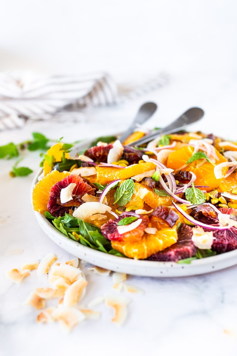 citrus salad This Moroccan-inspired Citrus Salad with dates, arugula, mint, pistachios, and toasted coconut is dressed in the most flavorful Citrus Shallot Vinaigrette. It's deliciously juicy and vegan! #citrussalad #orangesalad