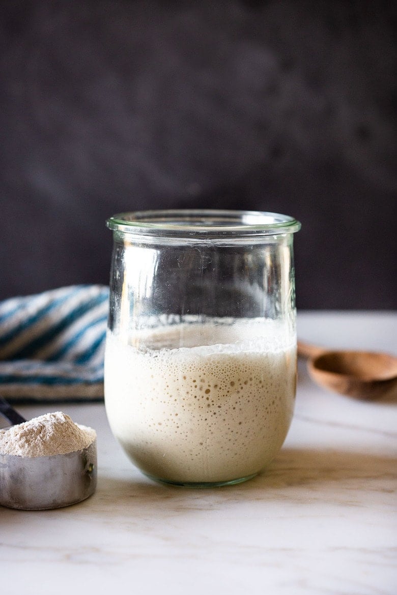How to make your own Sourdough Starter, using simple ingredients with no special equipment, in 5-8 days, that can be used in crusty bread, pizza dough, waffles, pancakes, and rolls- instead of using yeast. Sourdough Starter is "wild" yeast, made from flour and water and the wild yeast in the air around us.