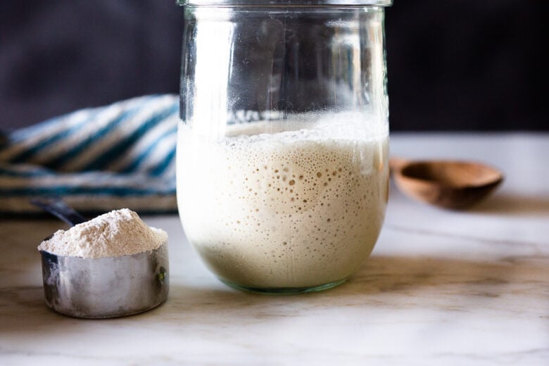 Bubbly sourdough starter in a jar.