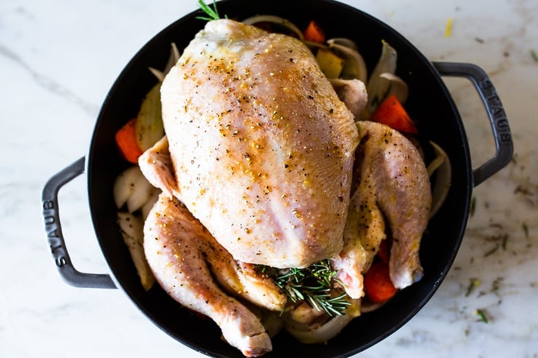 A simple easy recipe for roast chicken with lemon, garlic and rosemary, baked in the oven over vegetables. A delicious dinner recipe that can be turned into other meals during the week!