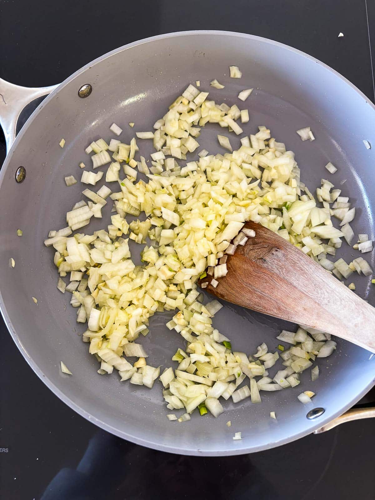 sautéing onion and garlic in olive oil in a large pan. 