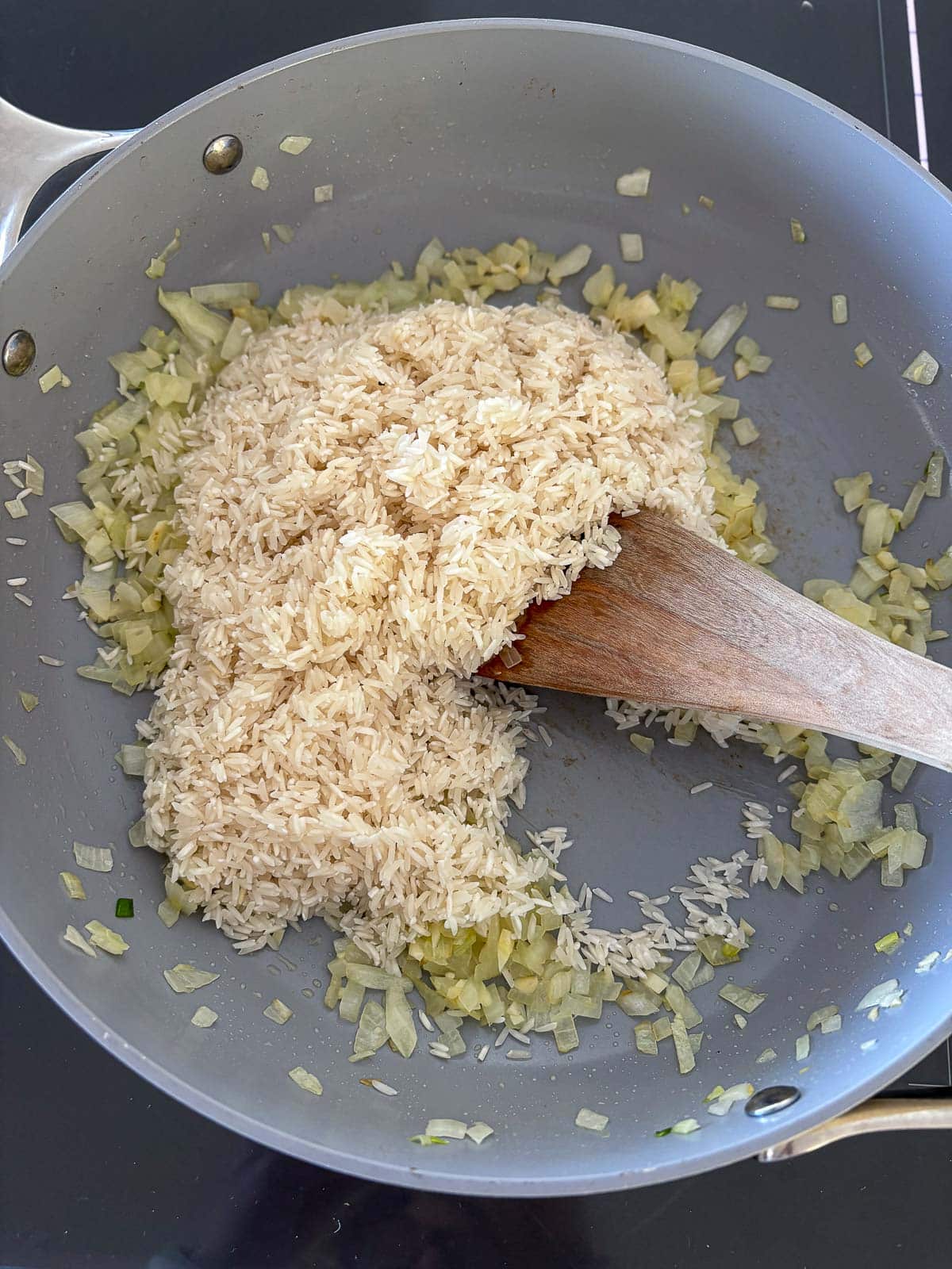 Added the rinsed rice and sauting with the onions and garlic. 