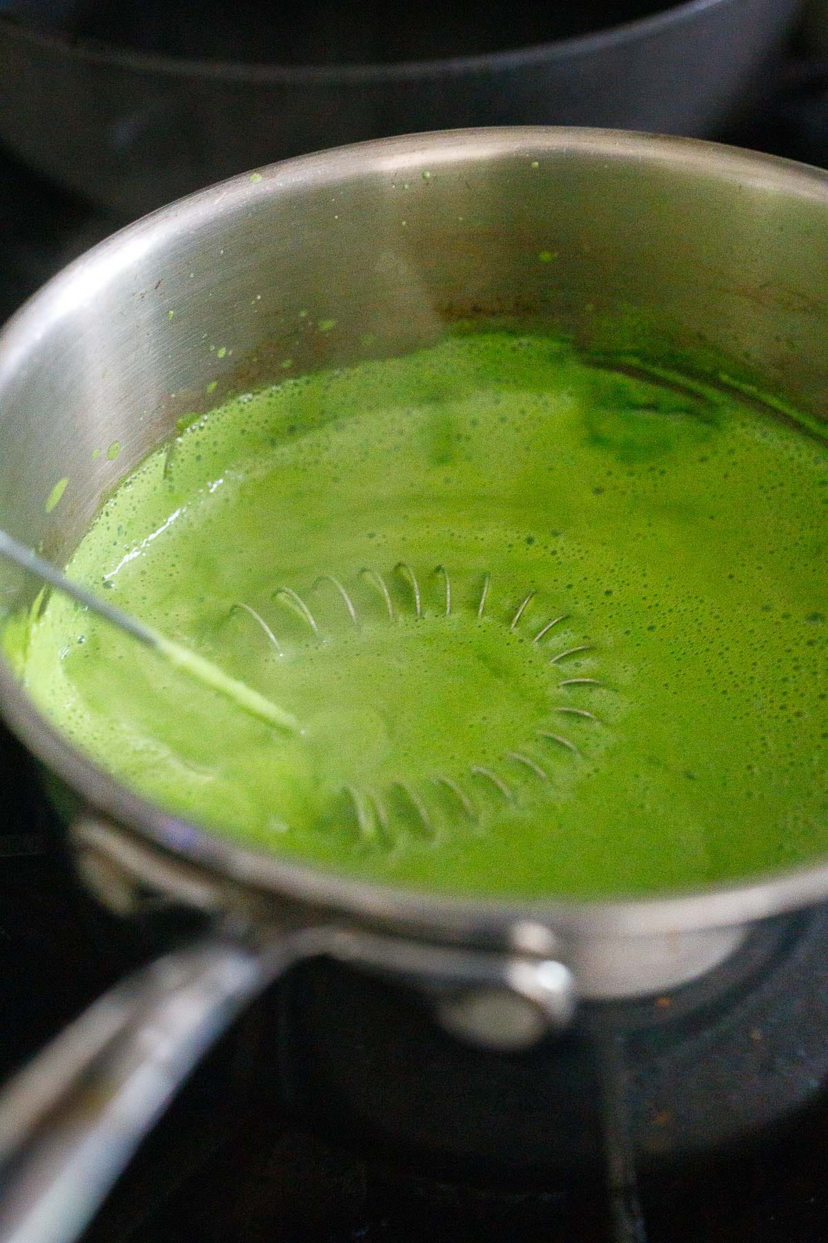 Thickening the sauce on the stove.
