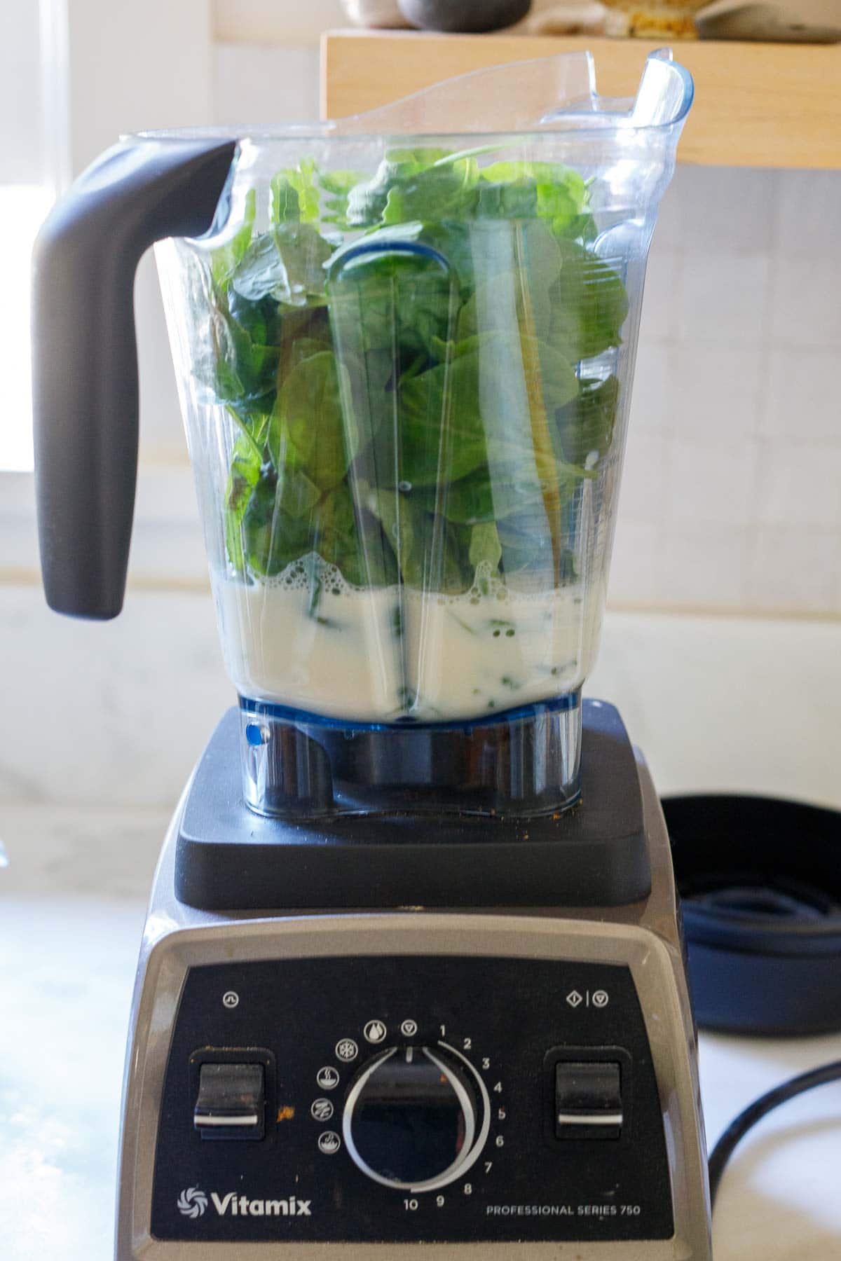 Blending spinach sauce ingredients.