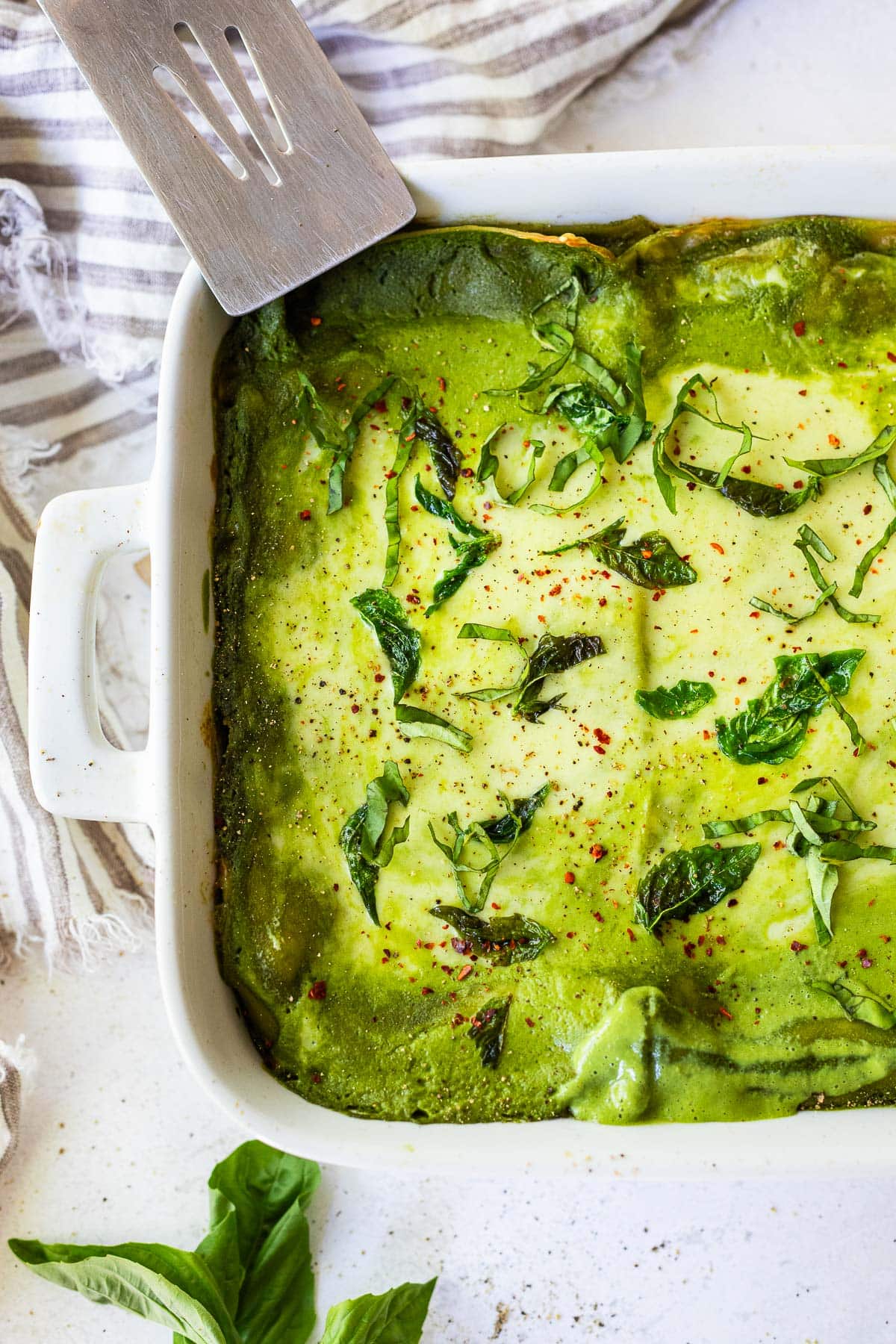 A delicious recipe for Spinach Lasagna filled with savory spinach and your choice of veggies and layered with a luscious Basil Spinach Sauce. Keep it vegetarian, or add chicken.