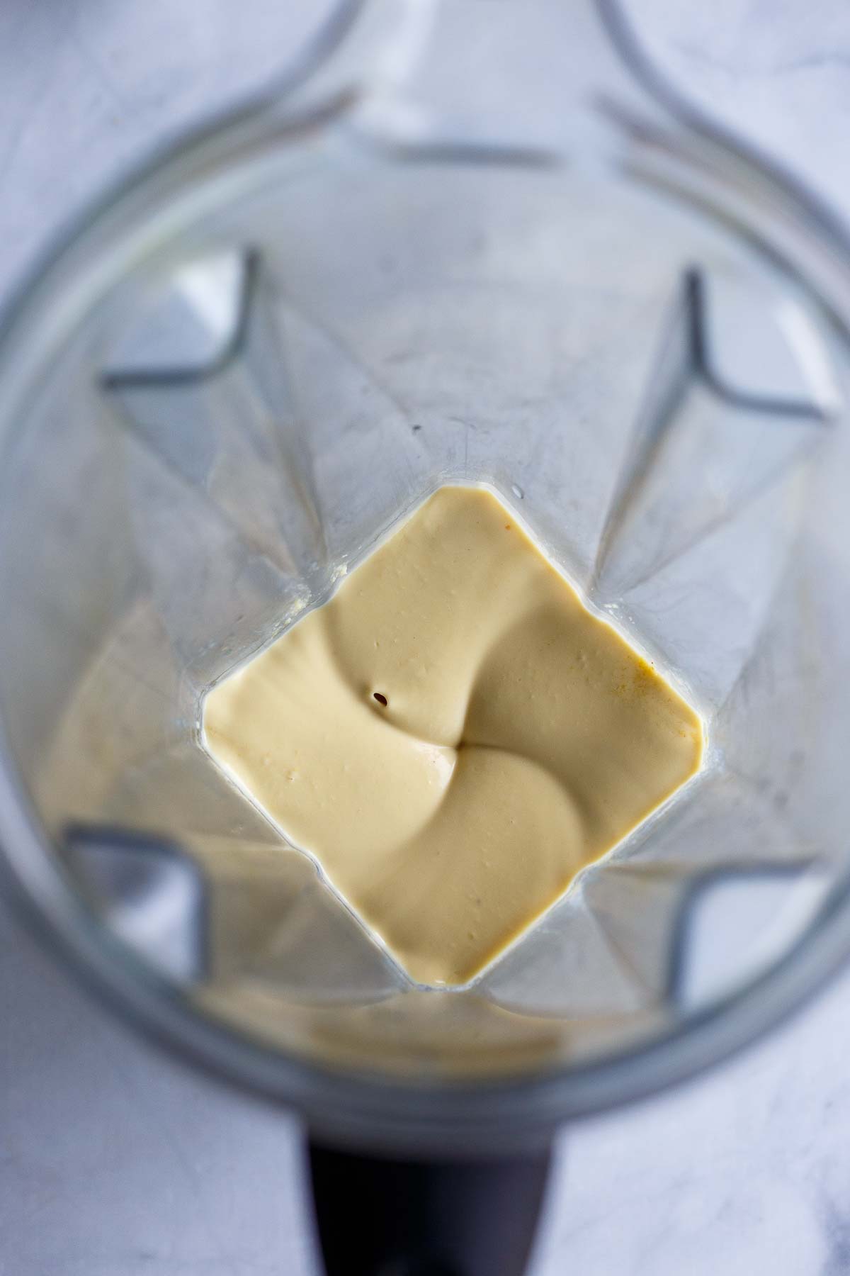 ingredients for vegan parmesan blending in blender to create a smooth texture.