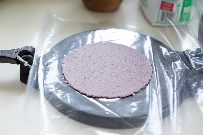 pressing dough into tortillas .