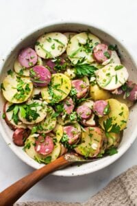 A simple French Potato Salad with fresh herbs - tarragon, parsley and chives, with a flavorful Dijon Vinaigrette. Healthy, vegan and light with no mayo!
