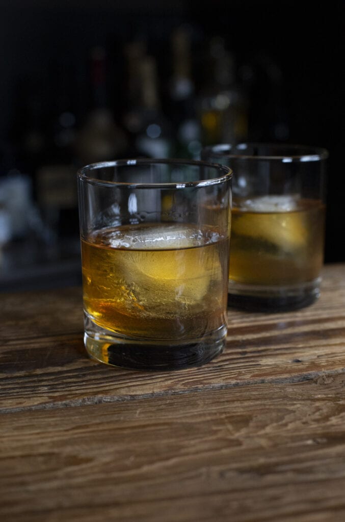 A classic old fashioned cocktail recipe served in a rocks glass with a big ice cube. 