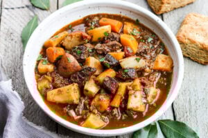 Get warm and cozy with this Instant Pot Beef Stew with Root Veggies- a hearty, comforting one-pot meal made in the pressure cooker, that is keto friendly, easy to make and full of depth and flavor. #beefstew #instantpotbeefstew #instantpot #bestbeefstew