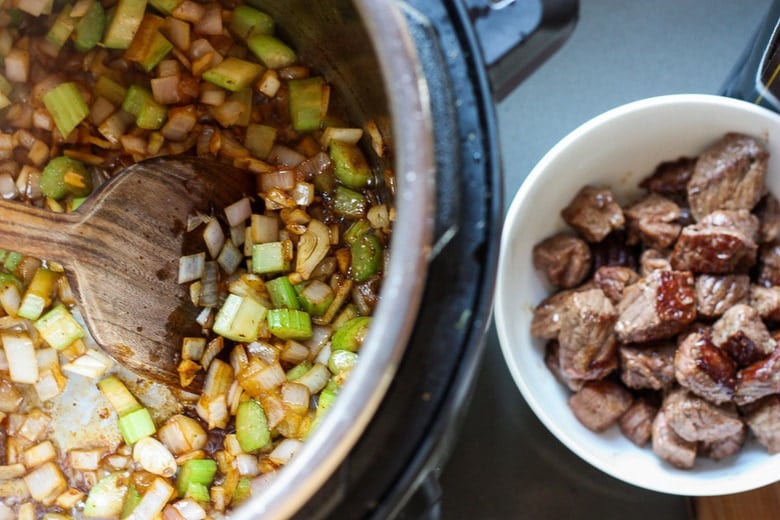 Get warm and cozy with this Instant Pot Beef Stew with Root Veggies- a hearty, comforting one-pot meal made in the pressure cooker, that is keto friendly, easy to make and full of depth and flavor. #beefstew #instantpotbeefstew #instantpot #bestbeefstew