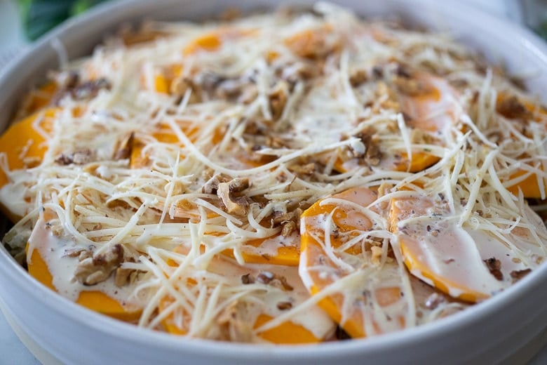 the top layer of the butternut squash gratin layered with cream, gruyere, and toasted walnuts. 