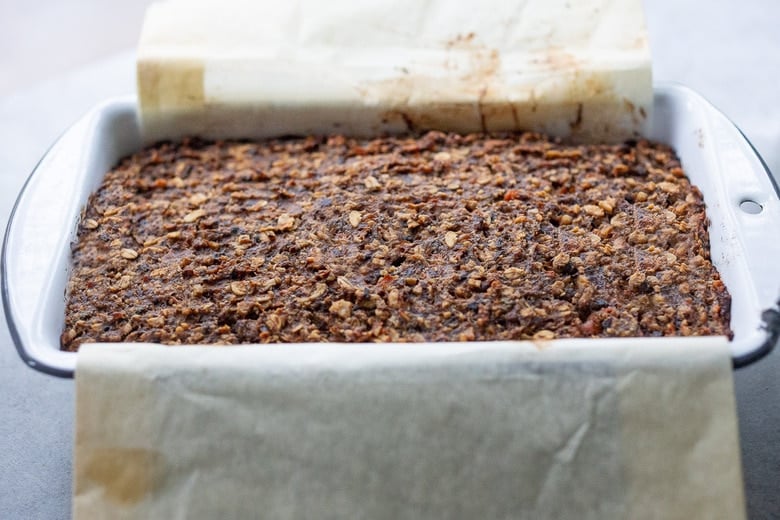baked mushroom loaf in loaf pan with slightly puffed surface. 