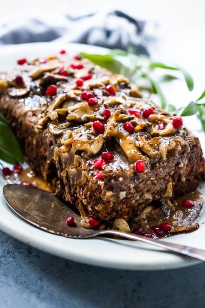 mushroom walnut roast loaf, topped with mushrooms and pomegranate seeds.