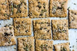 How to make homemade crackers from sourdough discard or starter. A quick, easy and adaptable recipe. These crackers are crisp, tangy and incredibly addicting! #sourdough #discard #crackers #crackersrecipe