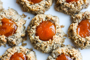 Thumbprint Cookies are a perfect treat for the holidays. A melt in your mouth rustic thumbprint cookie with rye, toasty walnuts, cardamom and tangy apricot jam- a perfect balance of flavors, decadent and lightly sweet with a satisfying crunch. #thumbprintcookies