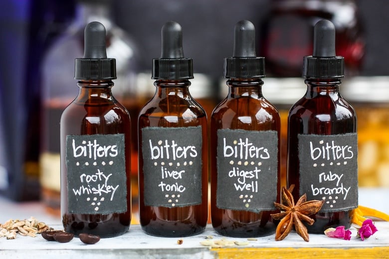 Four bitters recipes in drop bottles with labels.