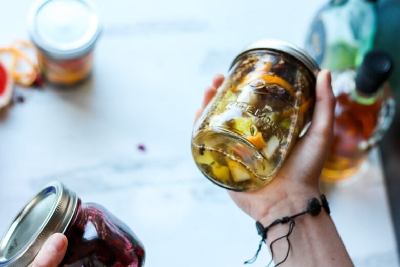 steeping and shaking bitters in mason jars.