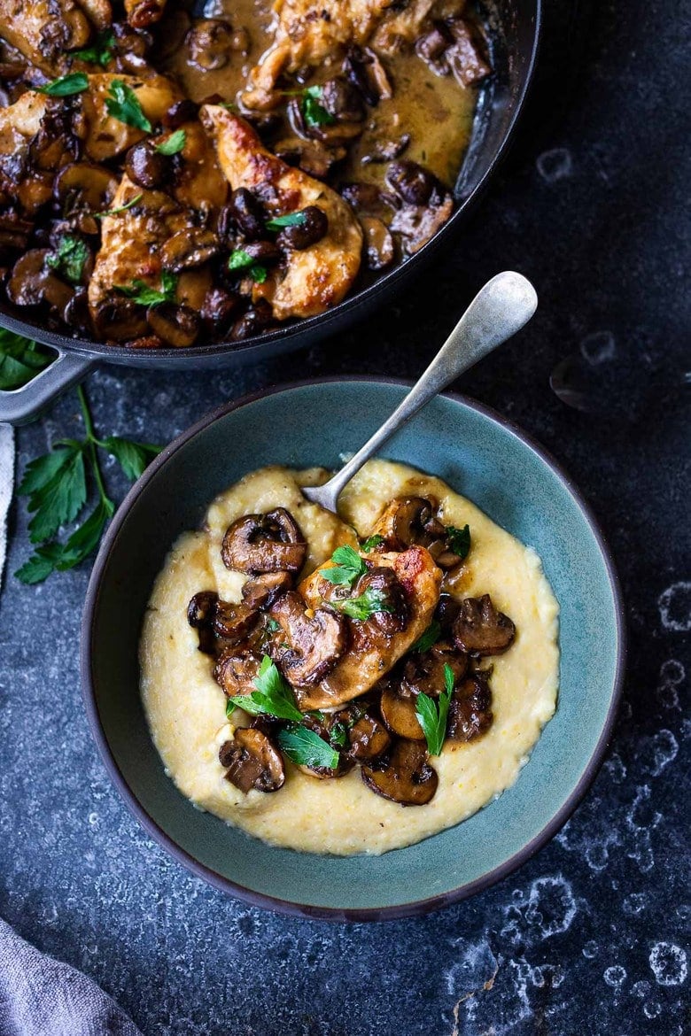 Classic Chicken Marsala served over creamy polenta.