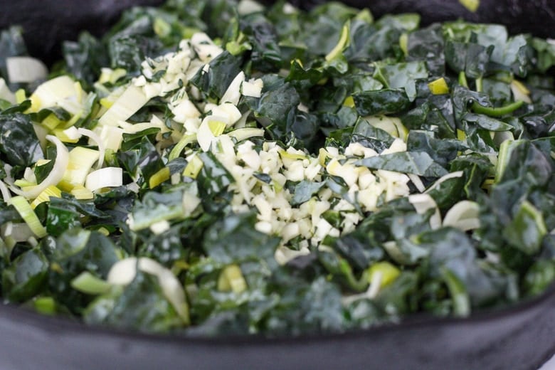 saute the leeks and kale in a large pan.